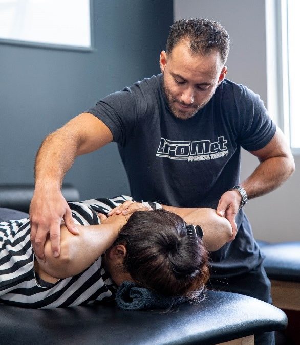 Image of therapist working on a female patient to convey the benefits of PT Training Queens - ProMet PT